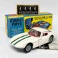 Corgi 324 Marcos 1800 GT - white body with green engine stripes, red interior with figure driver, wire wheels - Excellent Plus still a beautiful example in an Excellent Plus blue and yellow carded picture box - also comes with collectors club folded leaflet and unapplied racing numbers. 