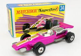 Matchbox Superfast 34d Formula 1 Racing Car (Superfast 34a) - metallic candy pink body with yellow stripe racing number 16 nose label, clear windscreen, bare metal base, 4-spoke wide wheels - Mint in Near Mint "New" type G box with "TM".