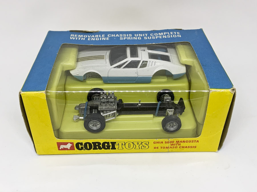 Corgi 271 Ghia 5000 Mangusta with De Tomaso Chassis - finished in two-tone white, blue, black interior with graphite grey detachable chassis and cast hubs (roof aerial is broken) otherwise Mint including plastic inner tray, outer blue and yellow window box is Good Plus (cellophane has been professionally replaced, repaired tear under window).